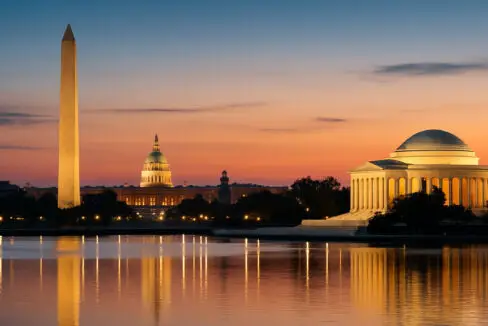 Washington, DC skyline at night featuring the Washington Monument and Lincoln Memorial.