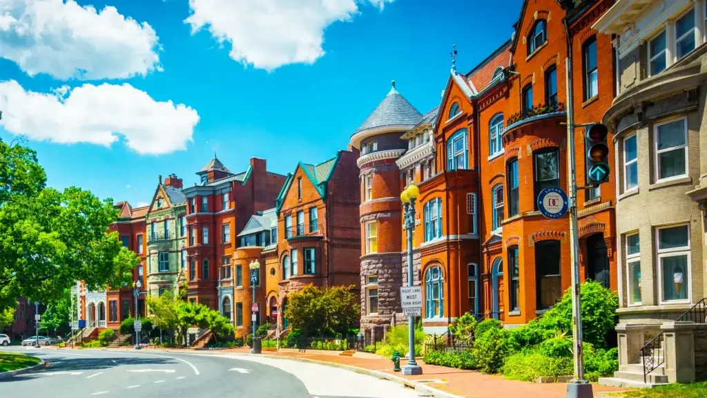 Logan Circle streetscape in Washington, DC featuring historic rowhomes, tree-lined sidewalks, and neighborhood park