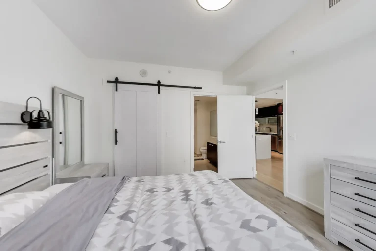 Primary Bedroom, View to Bath and Living Area — 1010 Massachusetts Ave NW #805, Washington, DC