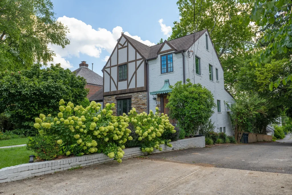 Tudor Revival home with half-timbered gable and blooming hydrangeas in American University Park, Washington, DC