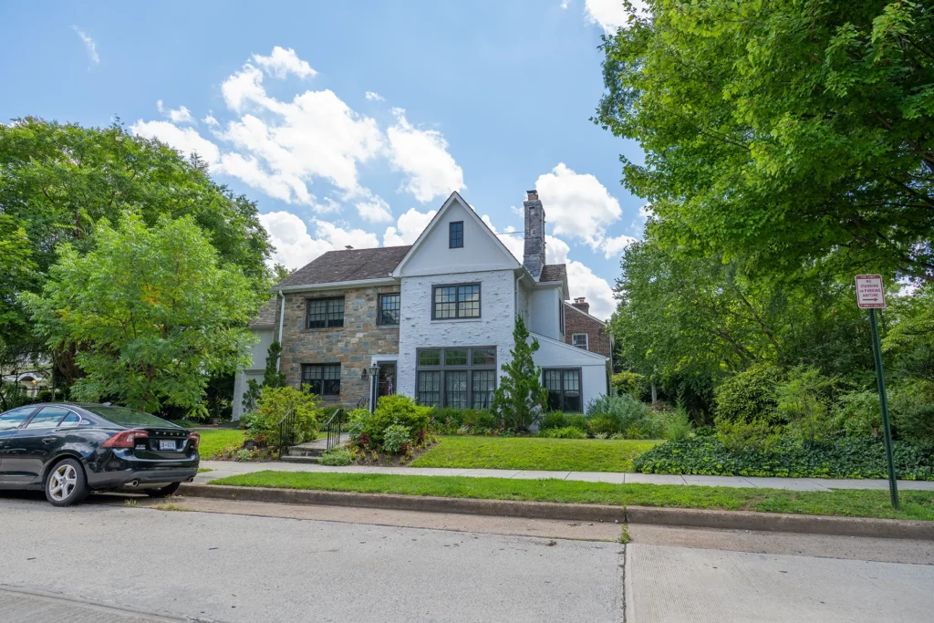 Renovated stone and white-brick home with large black-framed windows in American University Park, Washington, DC