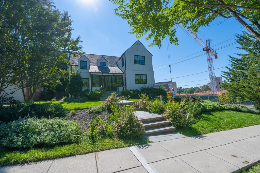 Modern farmhouse-style home above a terraced hillside garden in American University Park, Washington, DC