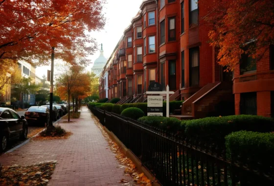 Capitol Hill brick rowhouses in autumn with a For Sale sign in a front garden and the US Capitol dome down the street.
