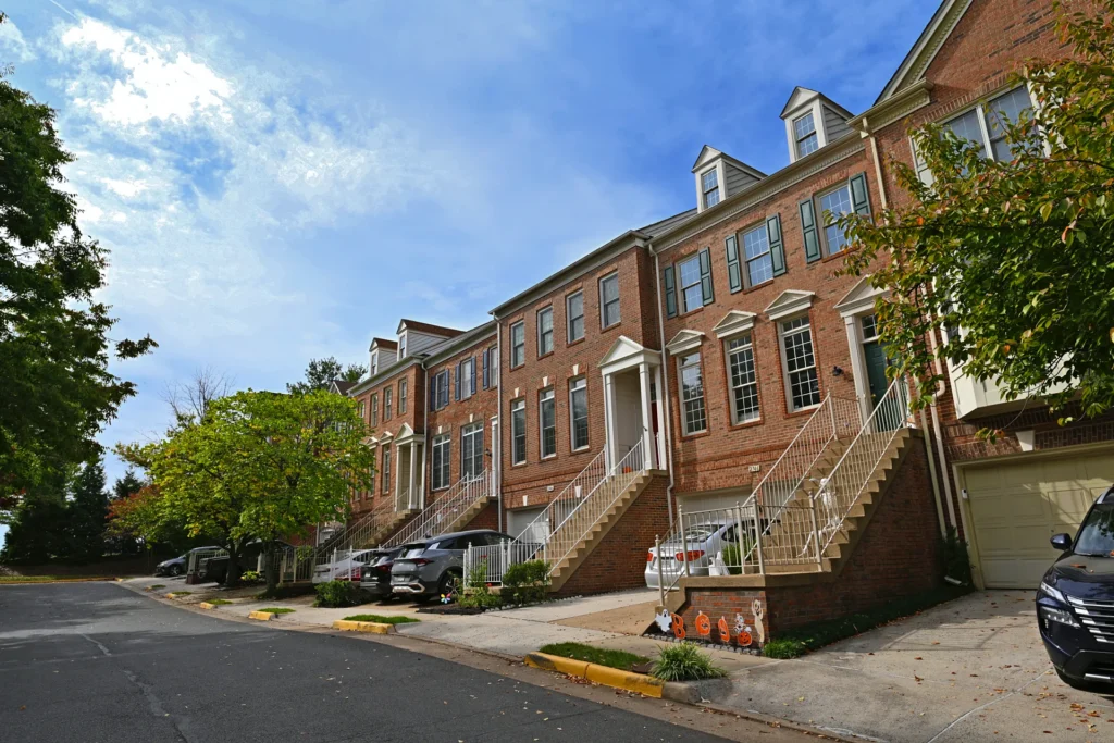 Row of brick townhouses with front stoops and lower-level garages in Virginia Center, Vienna VA