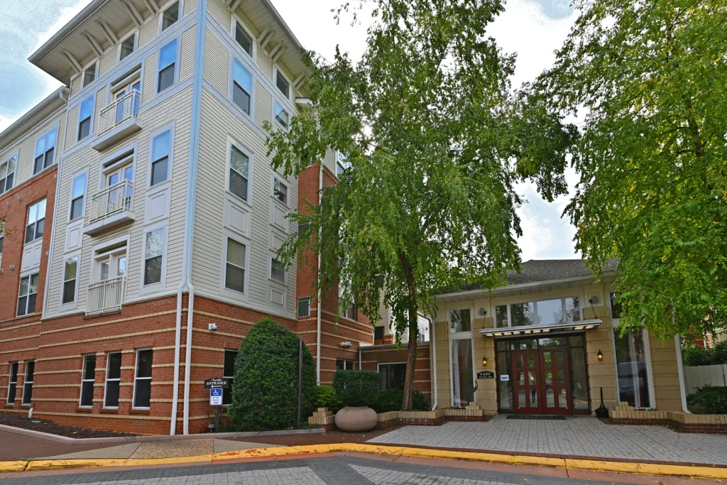 Four-story condominium building and gated entry off a paved motor court in Virginia Center, Vienna VA